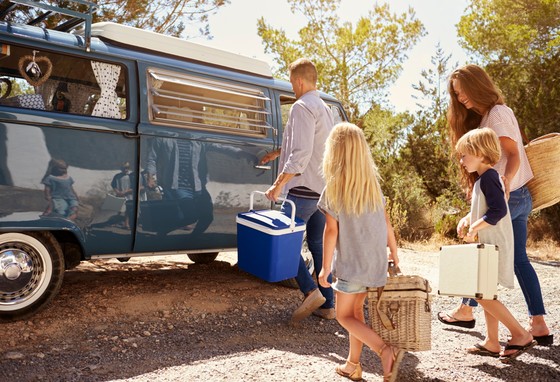 Family packing a touring caravan for a holiday
