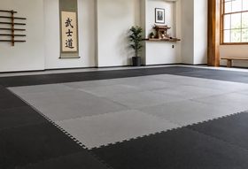 Interlocking foam mats laid out in a martial arts dojo